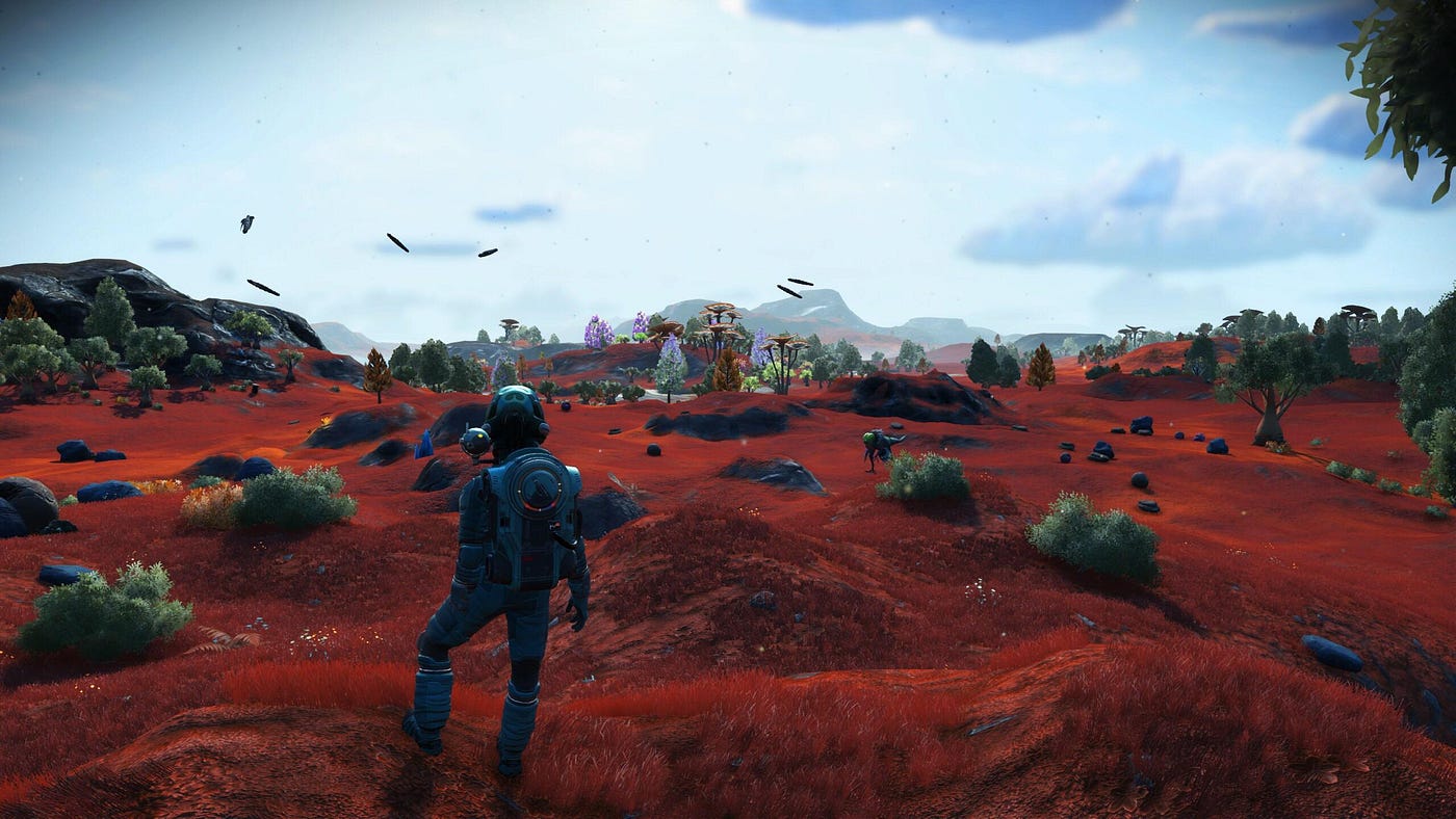 Explorer standing on a procedurally generated planet in No Man’s Sky with red terrain and alien fauna