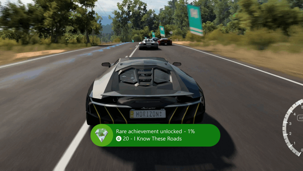 Forza Horizon gameplay screenshot showing a rare Xbox achievement unlocked pop-up on the road.