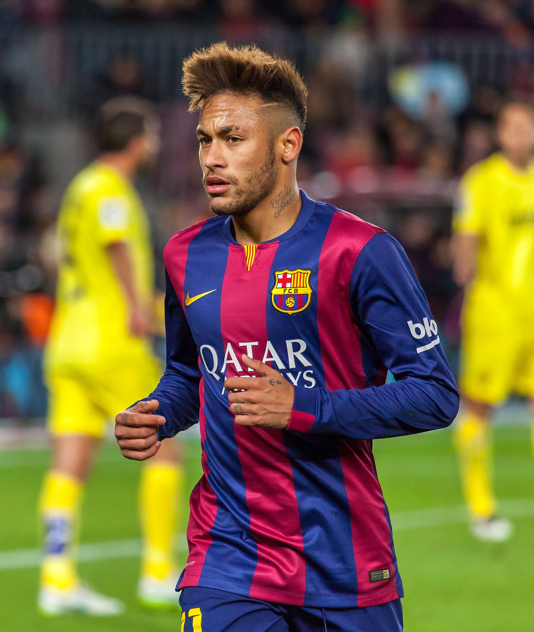 Neymar in a Barcelona kit during a match, running on the pitch with blurred players in the background.