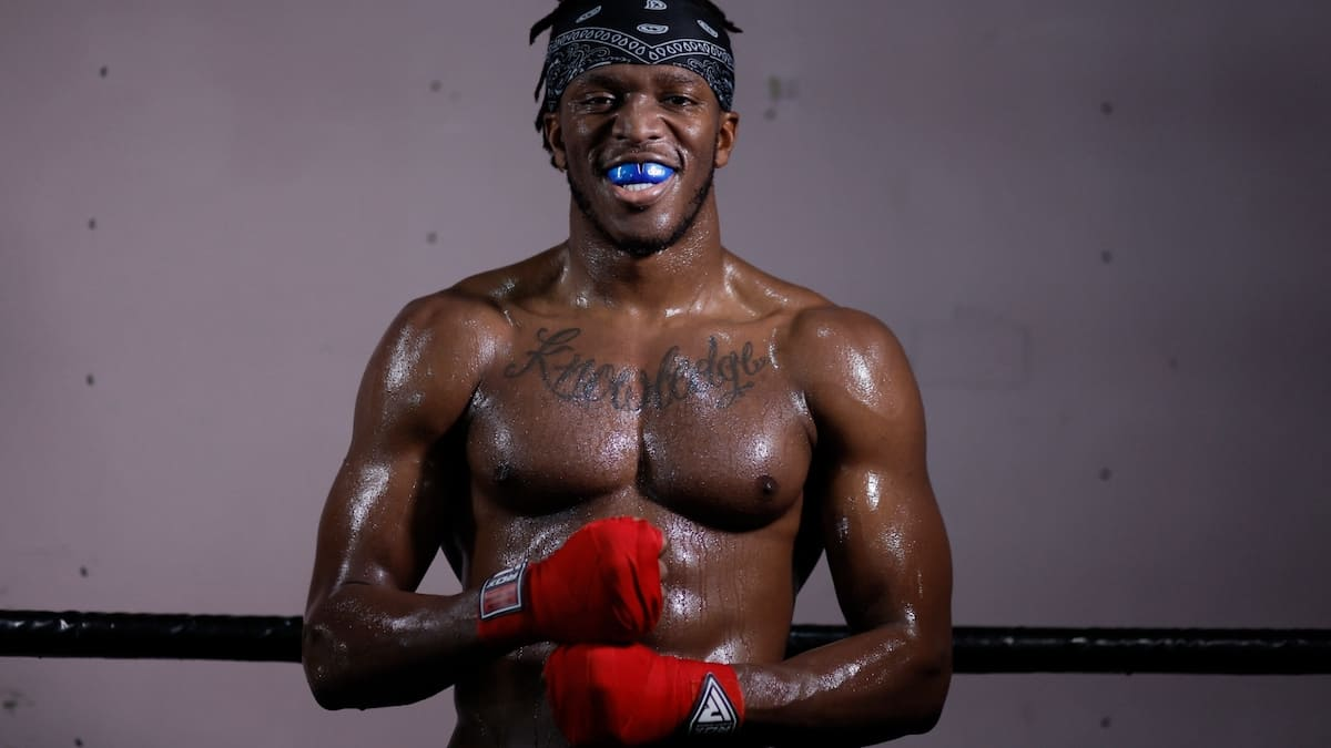 KSI posing in a boxing ring during a photoshoot, gloves on and looking confident, symbolizing his role as the pioneer who sparked the influencer boxing movement.