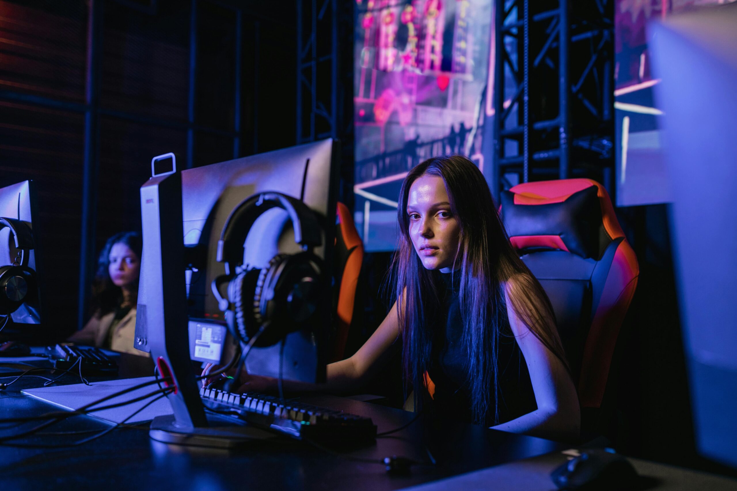 esports competitor focused at her gaming station during an event