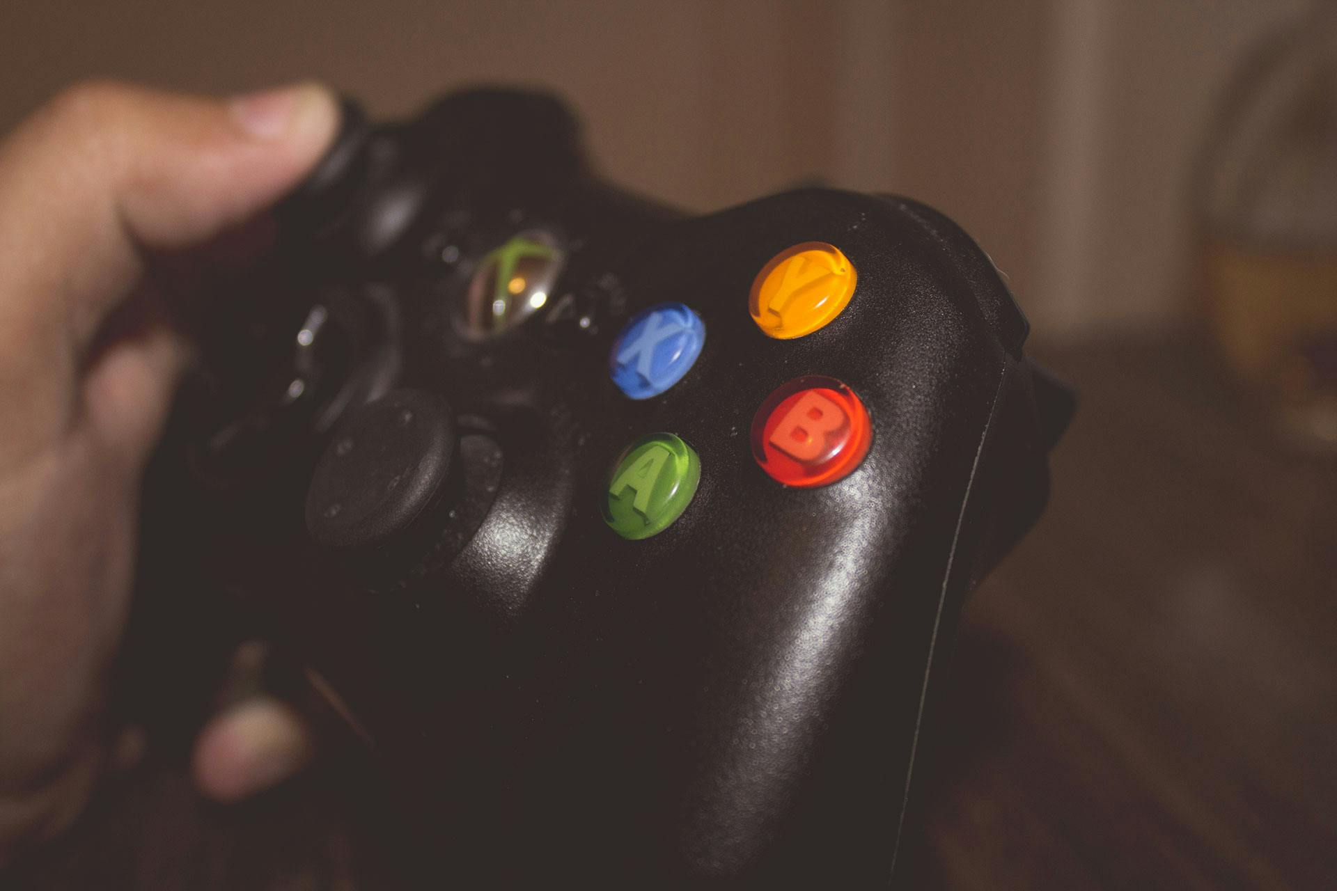 close up of an Xbox 360 controller showing the coloured face buttons