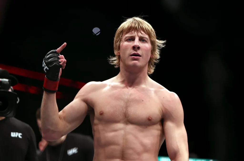 Paddy Pimblett gestures to the crowd after a UFC fight victory.