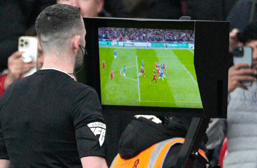A close up view of a VAR offside check on the pitch side monitor during a Premier League match.