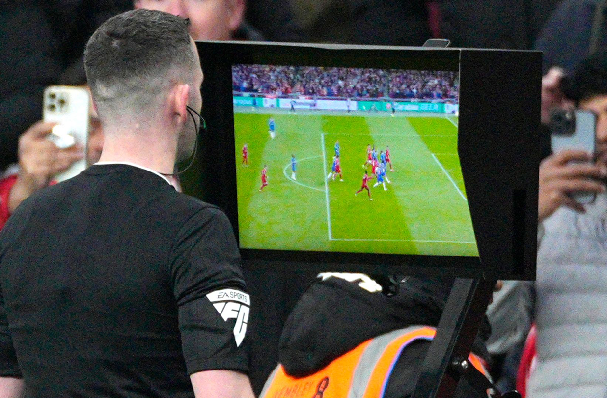 A close up view of a VAR offside check on the pitch side monitor during a Premier League match.