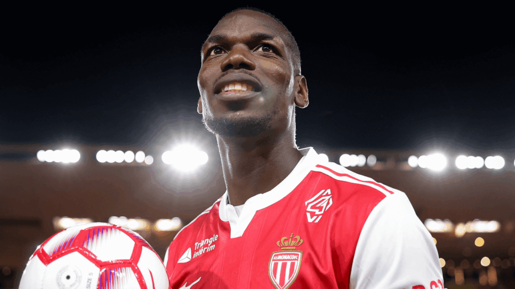 Paul Pogba wearing his Monaco football jersey on the pitch, focused and ready for action.