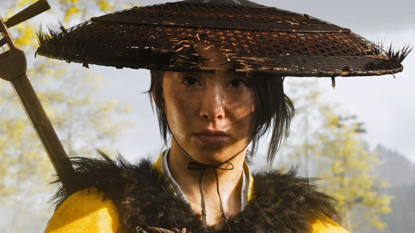 lose-up of Atsu from Ghost of Yōtei, showcasing his determined expression and detailed armor, highlighting his depth as a protagonist in the epic revenge story.