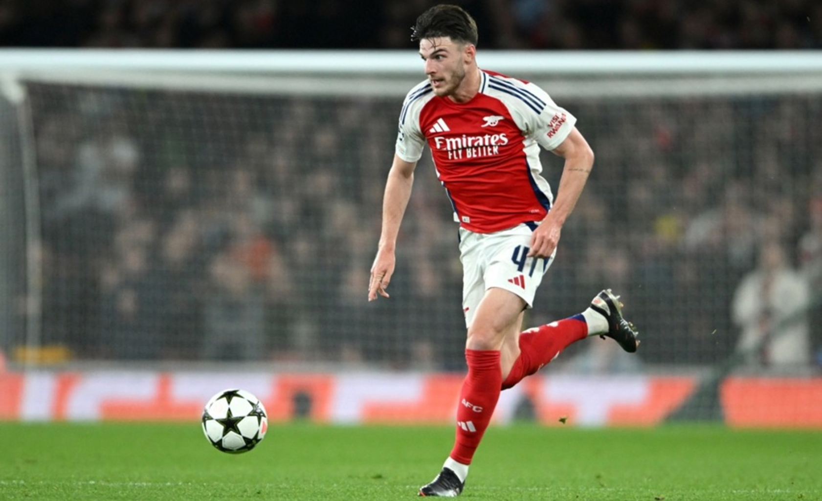 Arsenal midfielder driving forward with the ball during a Premier League match at the Emirates Stadium