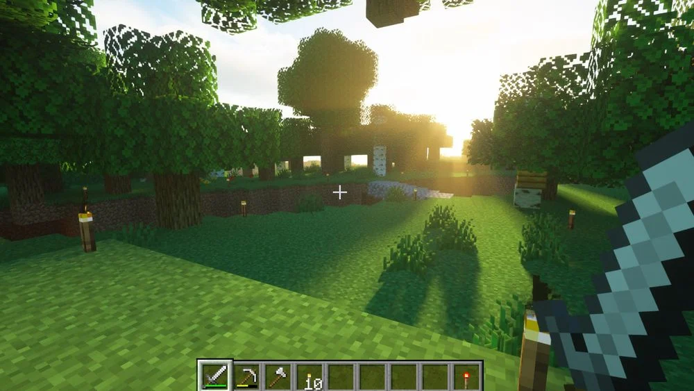 Minecraft survival mode gameplay showing a forest environment at sunset.
