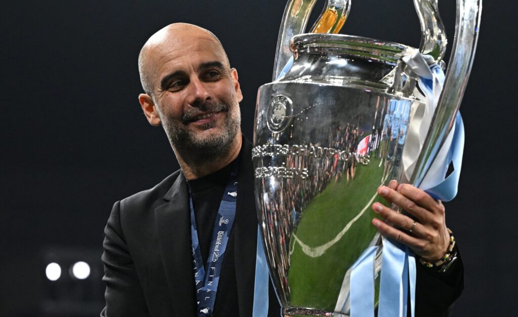 Pep Guardiola holding the UEFA Champions League trophy after Manchester City victory