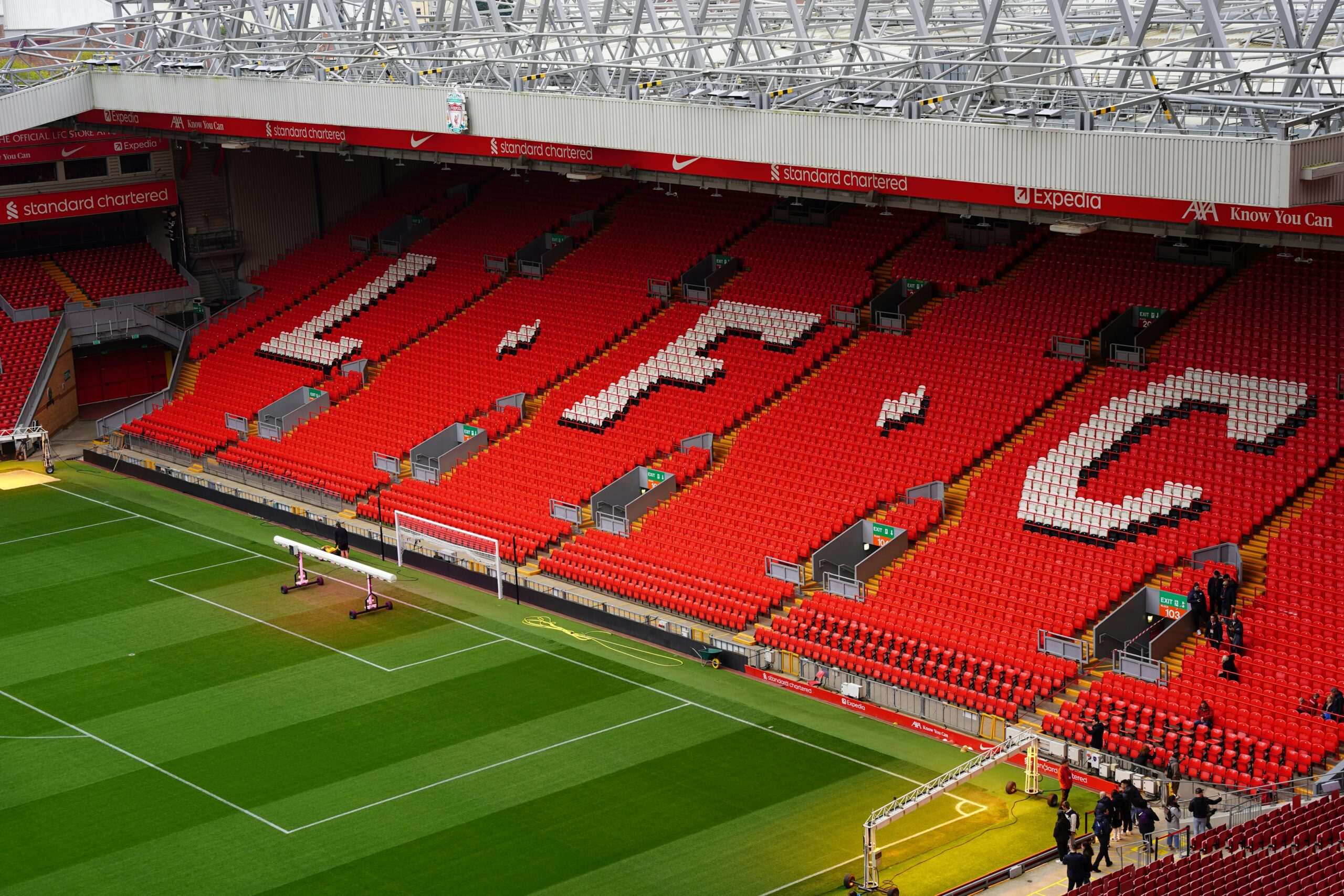 Liverpool FC’s Anfield stadium showing the red seating with L.F.C spelled out above the goal area.