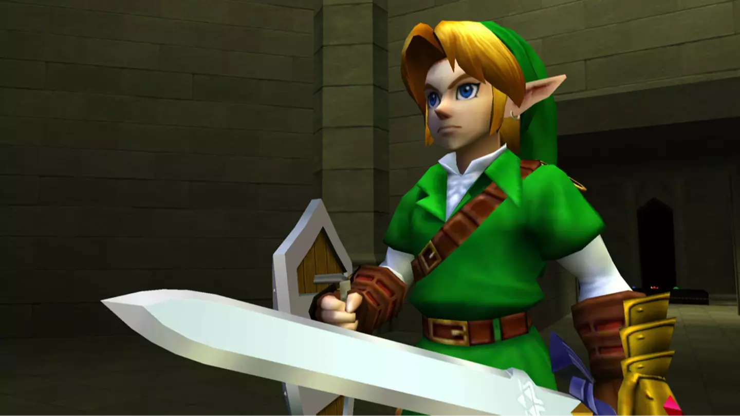 Link holds his sword inside a dungeon in The Legend of Zelda Ocarina of Time.