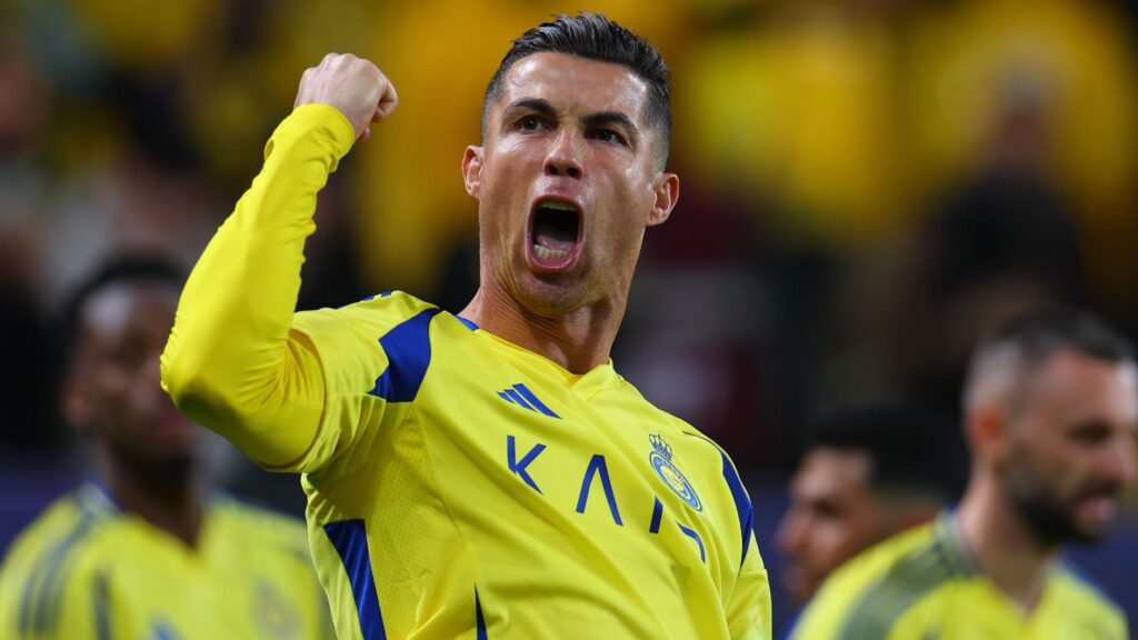 Cristiano Ronaldo celebrating a goal for Al-Nassr, showing his signature exuberance on the pitch in front of cheering fans.