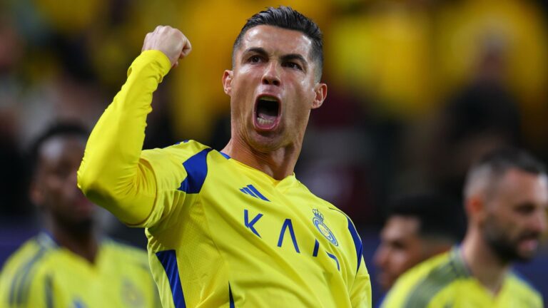 Cristiano Ronaldo celebrating a goal for Al-Nassr, showing his signature exuberance on the pitch in front of cheering fans.