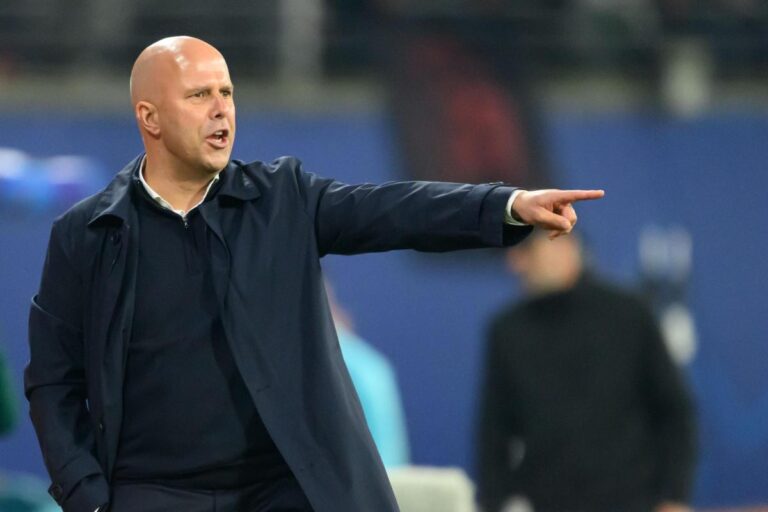 Arne Slot giving tactical instructions from the touchline during a professional football match