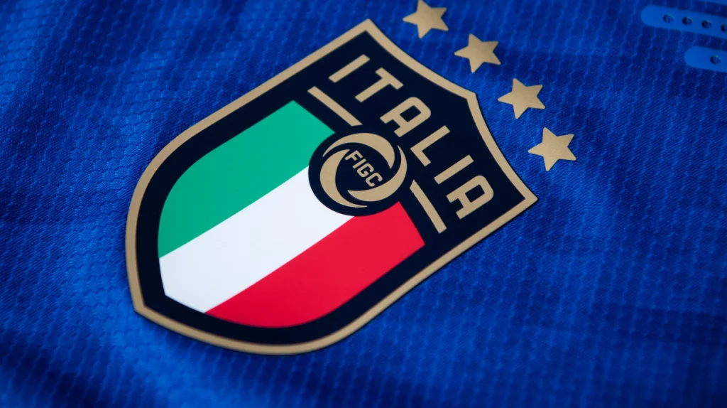 Italy national football team badge on blue shirt with four World Cup stars