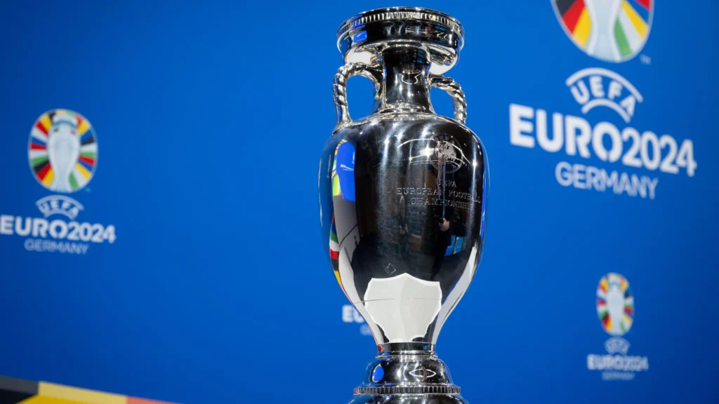 UEFA Euro 2024 trophy displayed in front of Germany 2024 branding