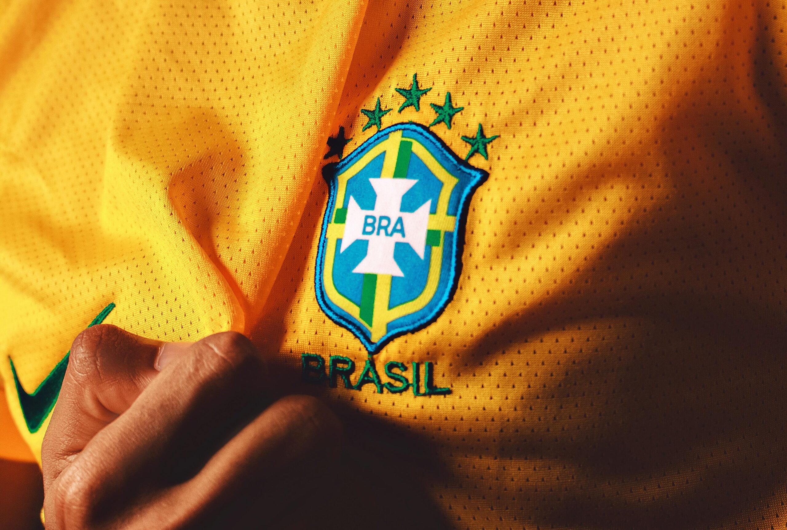yellow Brazil football team shirt with close up of badge