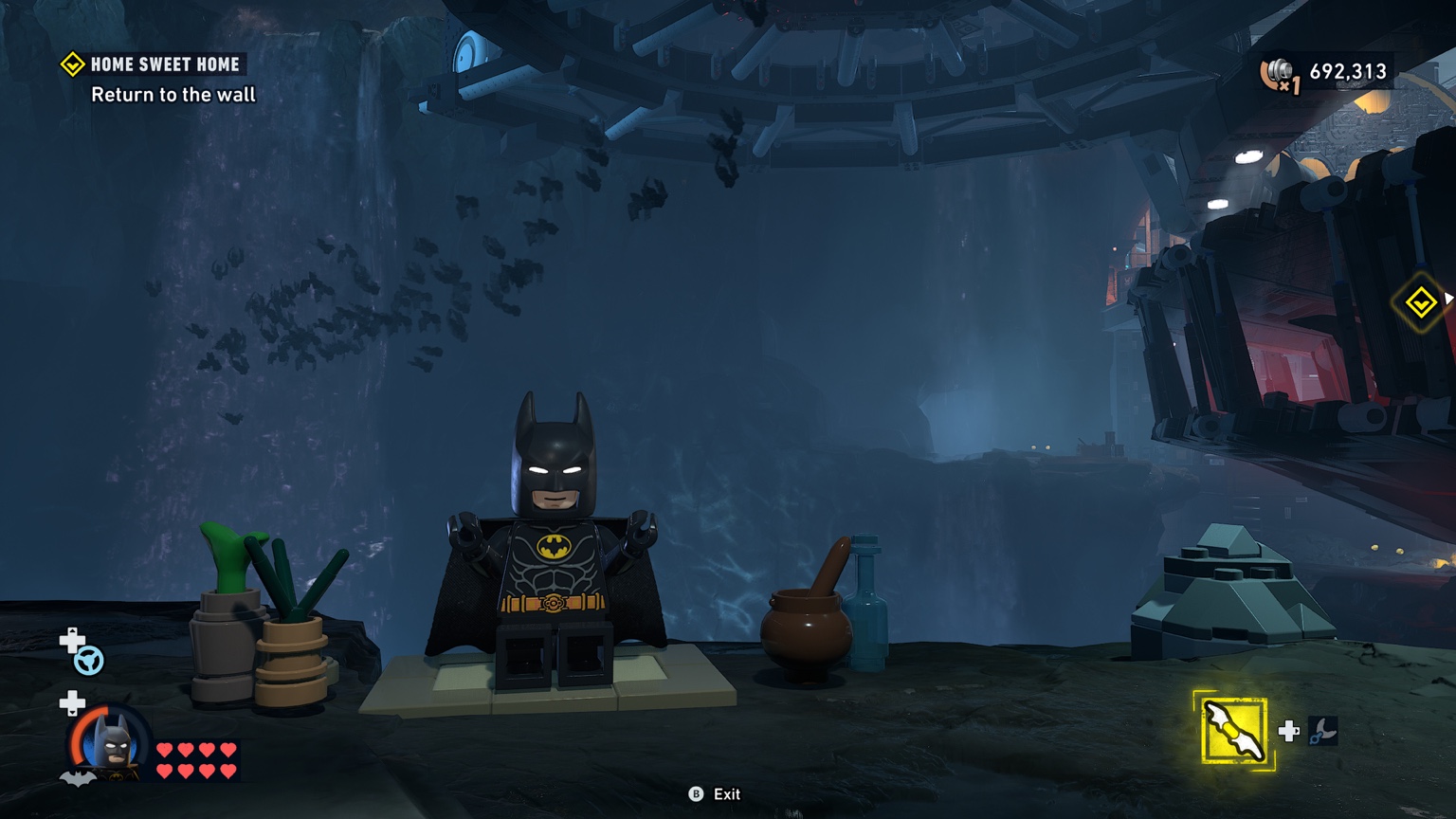 LEGO Batman standing in the Batcave during gameplay in LEGO Batman Legacy of the Dark Knight
