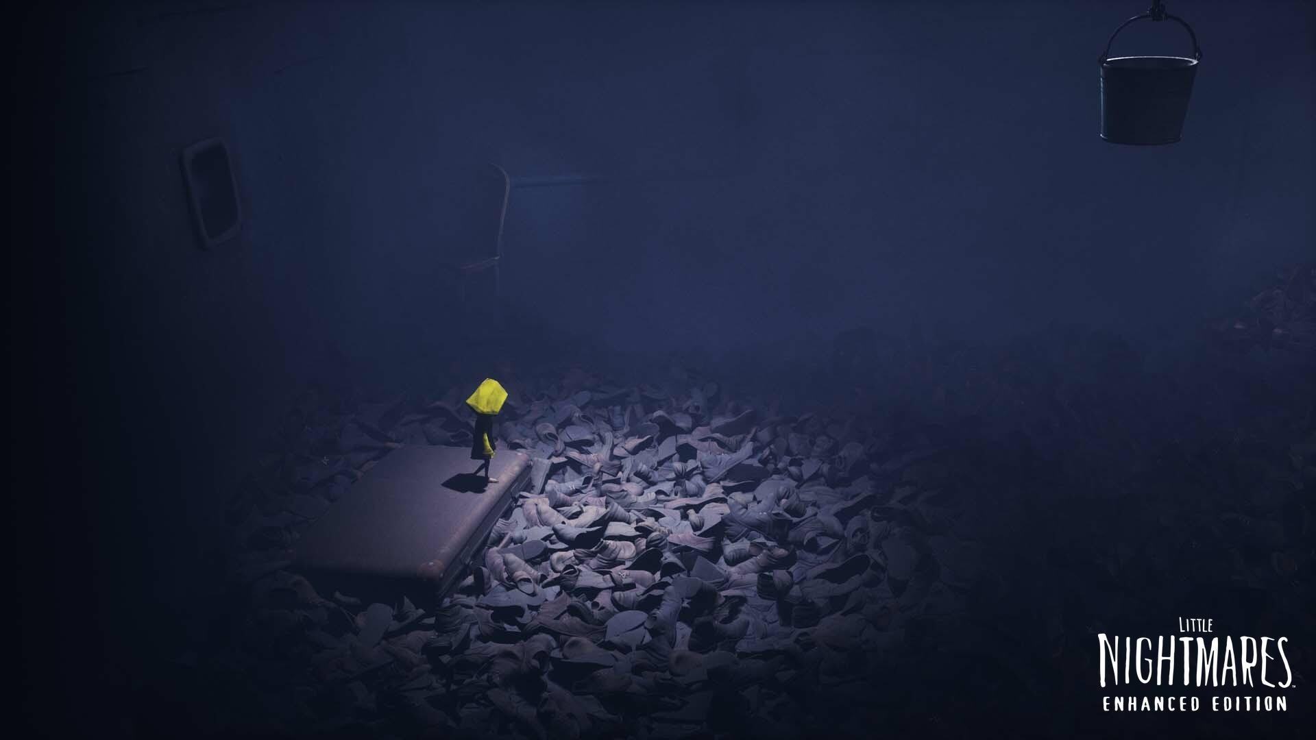 Six standing on a small platform surrounded by a sea of discarded shoes in a dark, cavernous room from Little Nightmares Enhanced Edition.